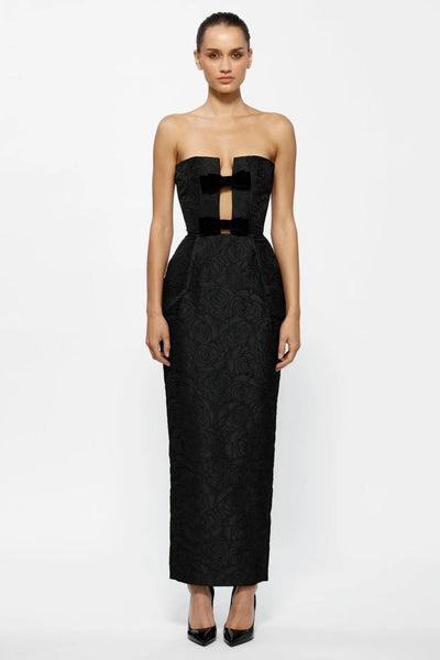 Black strapless dress with a large bow detail on a white background